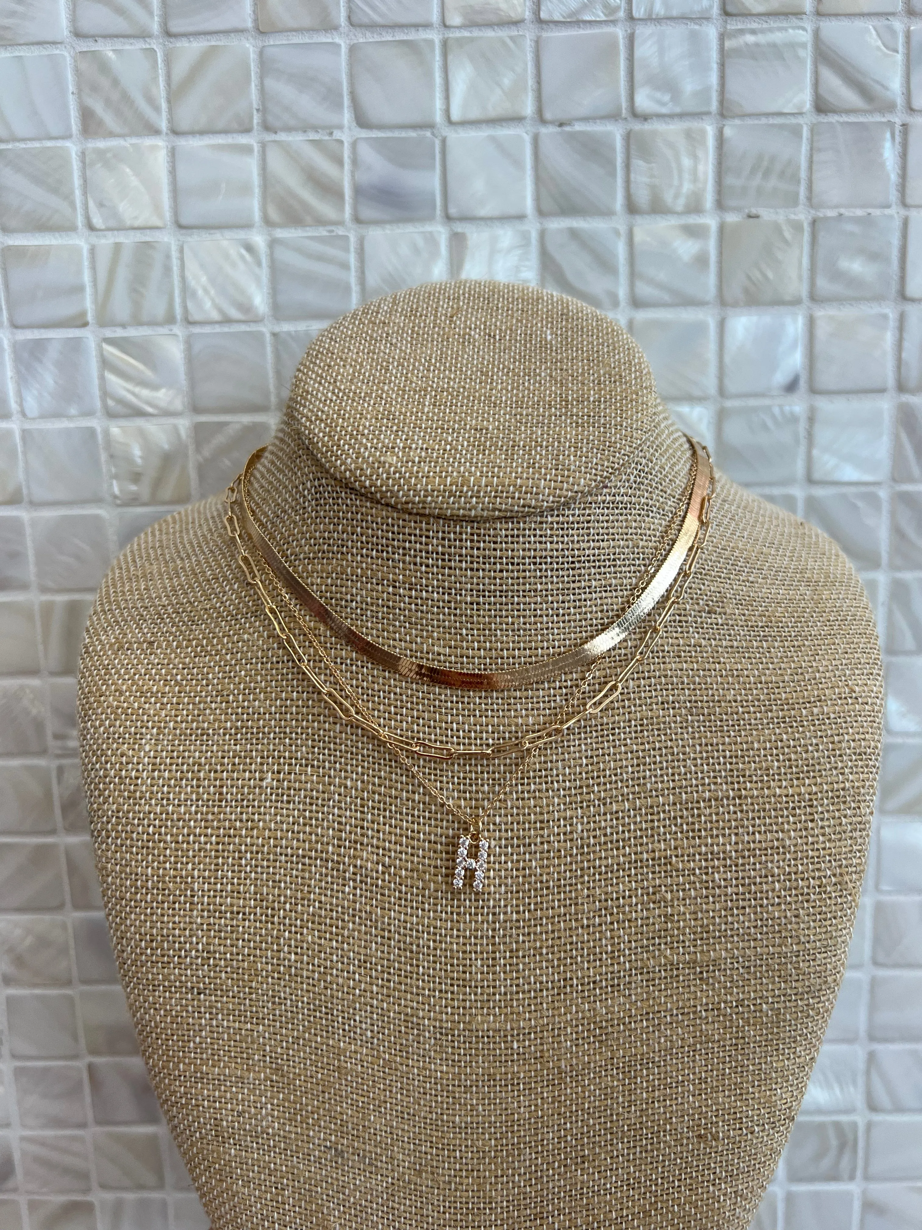 GOLD SNAKE, PAPERCLIP, AND CRYSTAL PENDANT INITIAL LAYERED NECKLACE